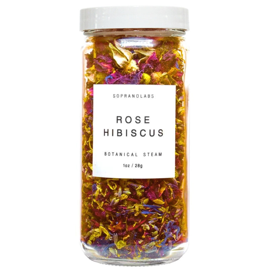 Glass jar filled with rose hibiscus botanical steam and a white label on a white background