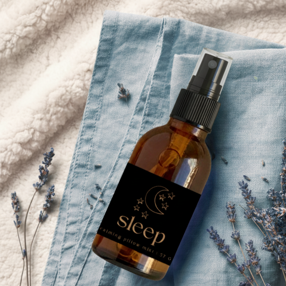 Brown spray bottle labeled 'sleep' on a textured fabric background with lavender flowers.