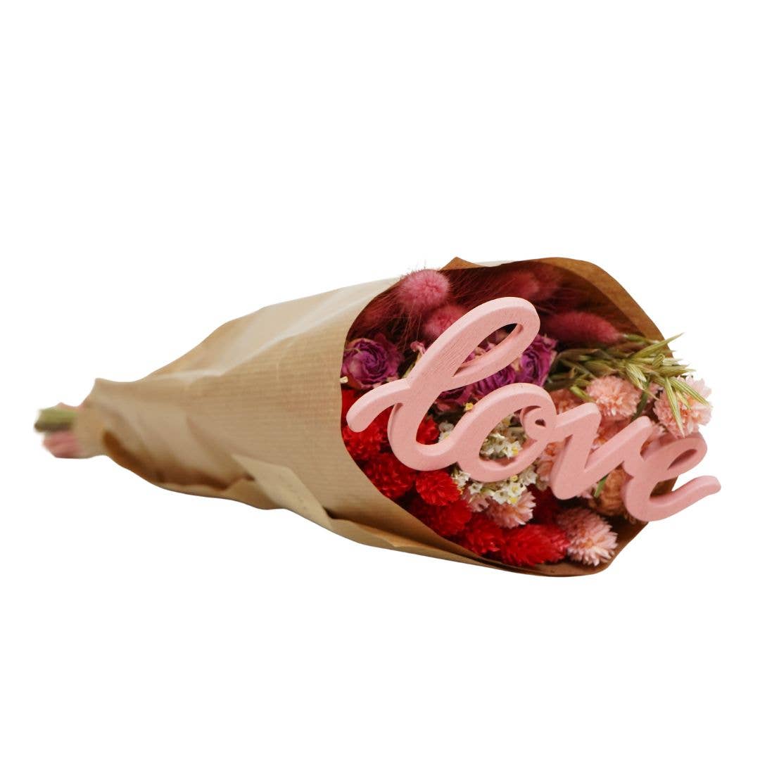Bouquet of flowers with a pink 'love' sign on a white background